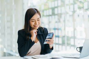 Asian Businesswoman Looking at Phone