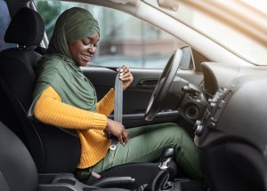 woman putting seatbelt on
