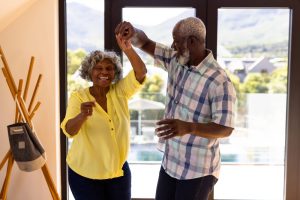 older couple dancing in living room